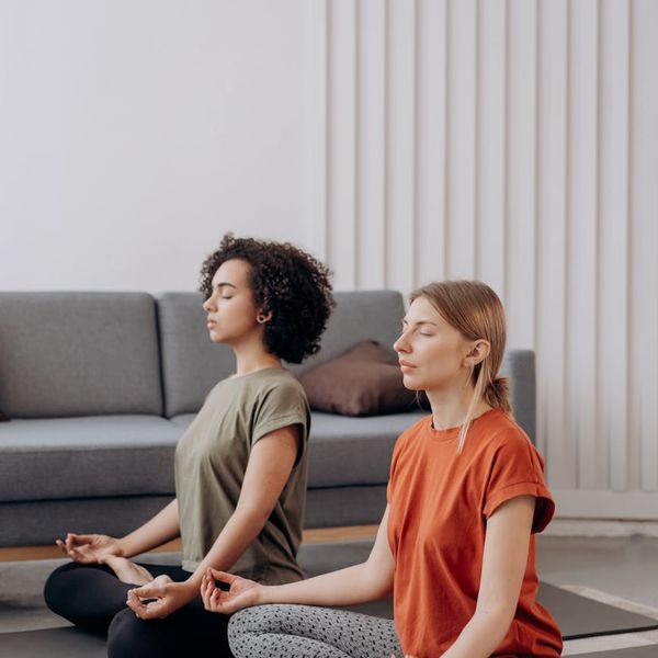 A person sitting in a calm meditation pose, surrounded by soft light.
